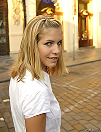 Iveta is wearing a white button up dress and looking casually beautiful