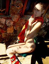 Tigra is modeling outdoors while she strips naked.