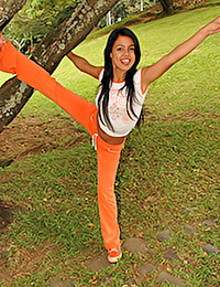 Those tight orange pants are magnificent on tasty model Gigi Spice.